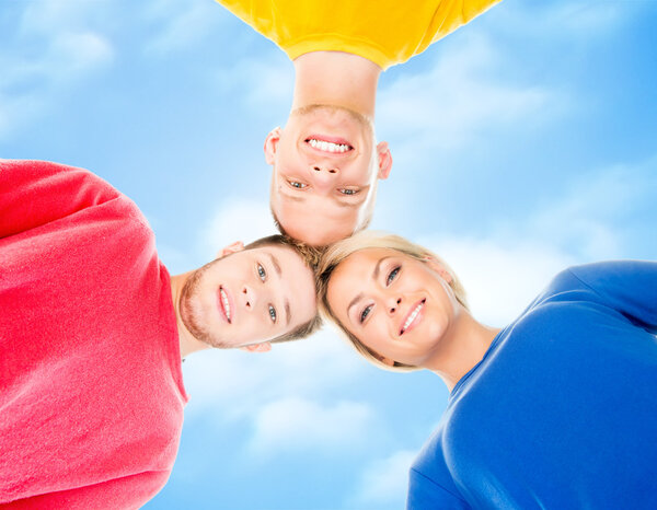 Happy students in colorful clothing standing together