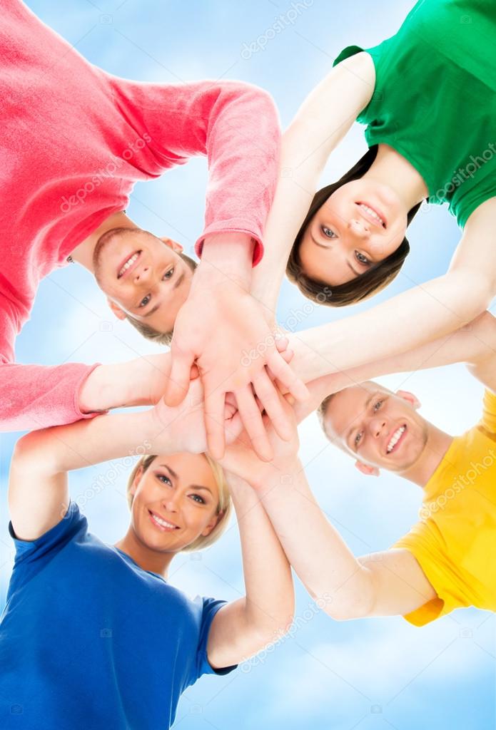 Happy students in colorful clothing standing together