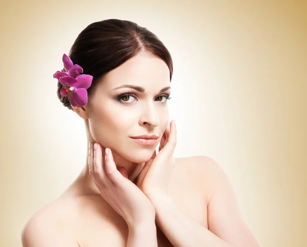 Healthy girl with an orchid flower — Stock Photo, Image