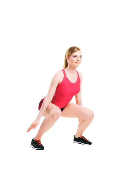 Fit vrouw in sportkleding doen van fysieke oefeningen — Stockfoto