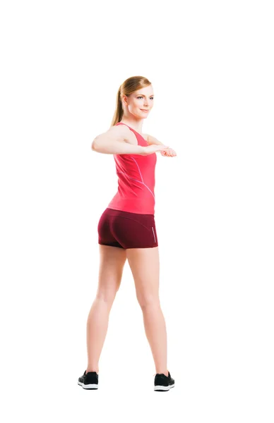 Vältränad kvinna i sportkläder göra fysiska övningar — Stockfoto