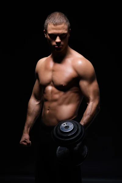 Bodybuilder man with a dumbbell — Stock Photo, Image