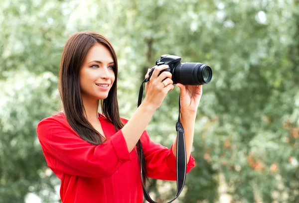Young amateur female photographer with a dslr camera Stock Picture