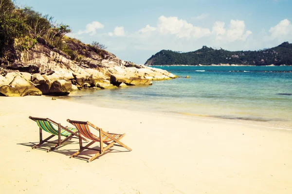 Liegestühle am tropischen Strand im Sommer — Stockfoto