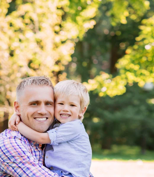 Son giving a hug to his father Royalty Free Stock Photos