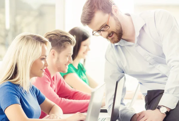 Group of teenage students and teacher — Stock Photo, Image