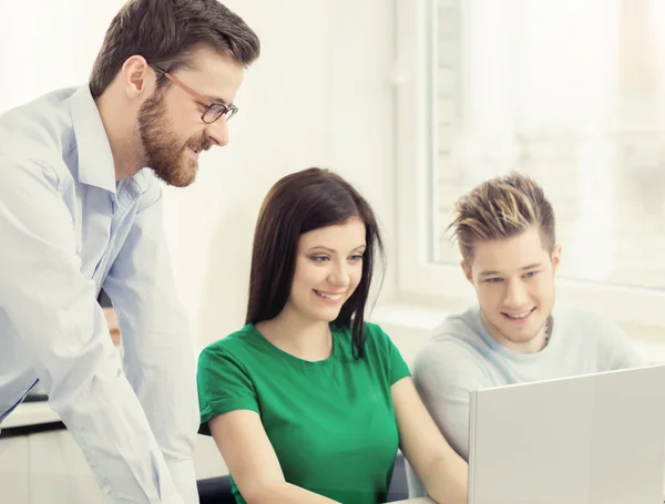 Group of teenage students and a teacher at the lesson — Stock Photo, Image