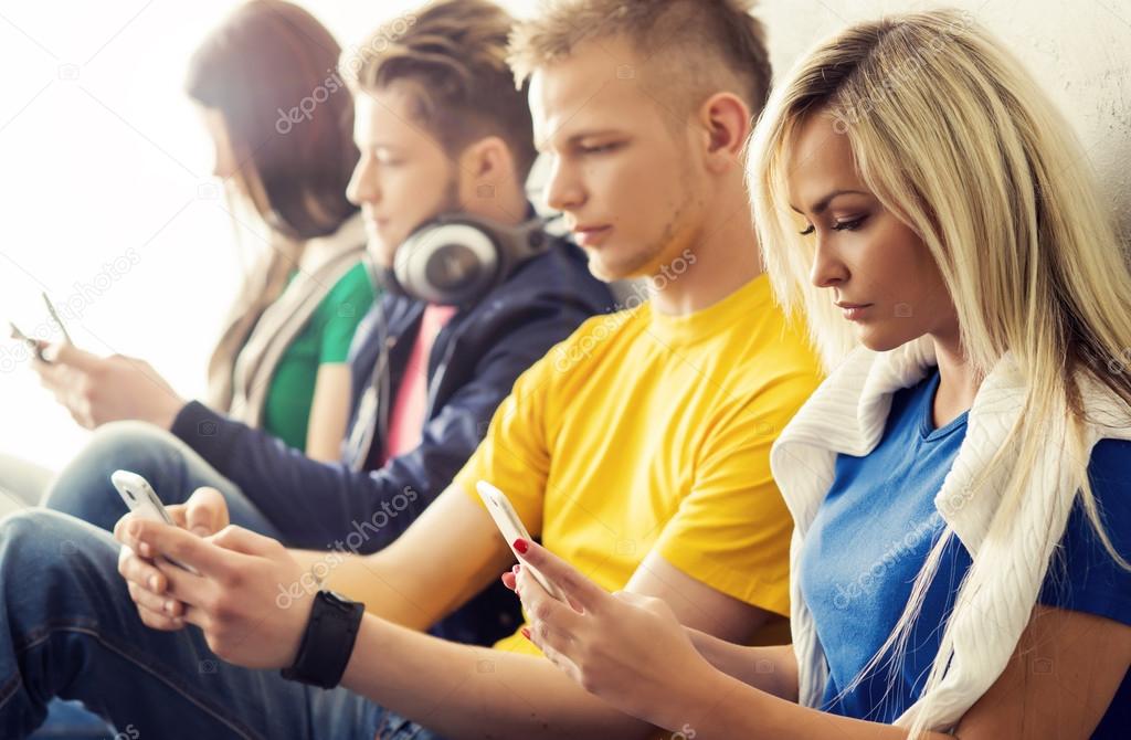 Happy students with smartphones