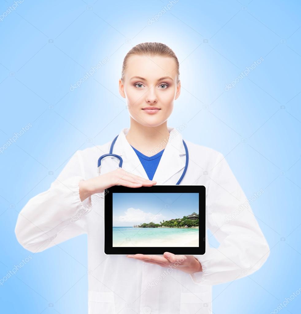 Young female doctor holding tablet