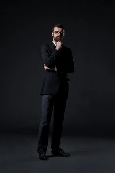 Businessman on black background — Stock Photo, Image