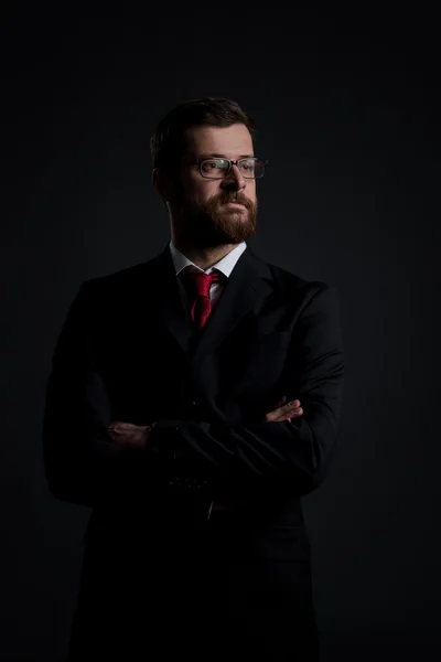 Portrait of businessman on black — Stock Photo, Image