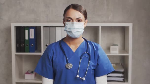 専門のイスラム教徒の医師は病院で働いています 保護マスクで若く魅力的な中東の女性医師の肖像画 医学的概念 — ストック動画