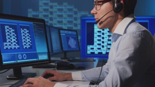 Pracovník call centra mluví s klientem po sluchátkách. Pracoviště operátora odborné pomoci. — Stock video