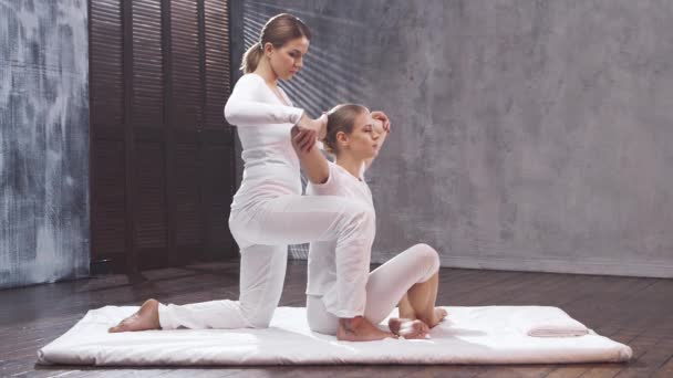 La giovane donna sta ricevendo un massaggio tailandese dal terapeuta. Tradizionale asiatico stretching terapia. — Video Stock