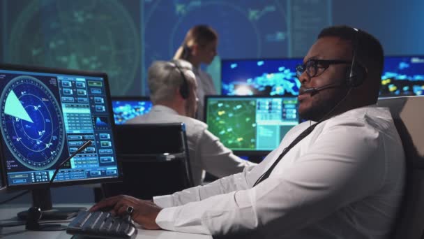 Workplace of the air traffic controllers in the control tower. Diverse team of aircraft control officers works using radar, computer navigation and digital maps. Aviation concept. — Stock Video