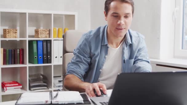 Freelance designer workplace at home office. Young man works using a computer and graphics tablet. Remote job concept. — Stock Video