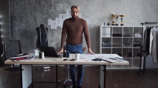 Workplace of young and talented fashion designer. Tailor works in stylish loft using sketches of clothes. — Stock Video