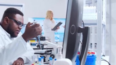 Profesyonel bilim adamları modern bir bilimsel araştırma laboratuvarında bir aşı üzerinde çalışıyorlar. Genetik mühendisliği işyeri. Fütürist teknoloji ve bilim konsepti.