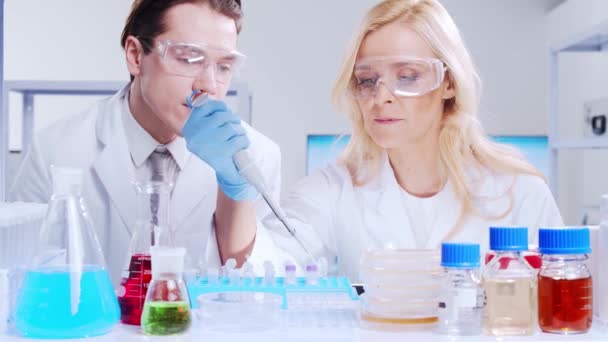 Επαγγελματική ομάδα επιστημόνων εργάζεται πάνω σε ένα εμβόλιο σε ένα σύγχρονο εργαστήριο επιστημονικής έρευνας. Στο χώρο εργασίας των γενετιστών. Μελλοντική έννοια της τεχνολογίας και της επιστήμης. — Αρχείο Βίντεο