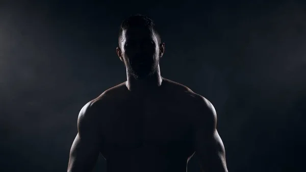 Fit and sporty bodybuilder over black background. Sportsman in studio. Sport and fitness concepts. — Stock Photo, Image