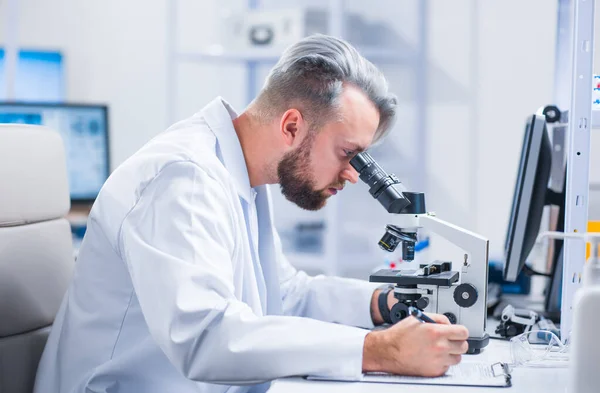 Professional scientist is working on a vaccine in a modern scientific research laboratory. Genetic engineer workplace. Future technology and science. Royalty Free Stock Images