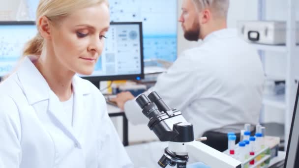 Professional team of scientists is working on a vaccine in a modern scientific research laboratory. Genetic engineer workplace. Future technology and science. — Stock Video