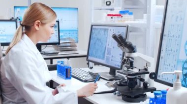 Profesyonel bilim adamları modern bir bilimsel araştırma laboratuvarında bir aşı üzerinde çalışıyorlar. Genetik mühendisliği işyeri. Gelecekteki teknoloji ve bilim.
