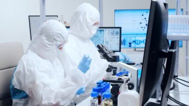 Profesyonel bilim adamları modern bir bilimsel araştırma laboratuvarında bir aşı üzerinde çalışıyorlar. Genetik mühendisliği işyeri. Gelecekteki teknoloji ve bilim.