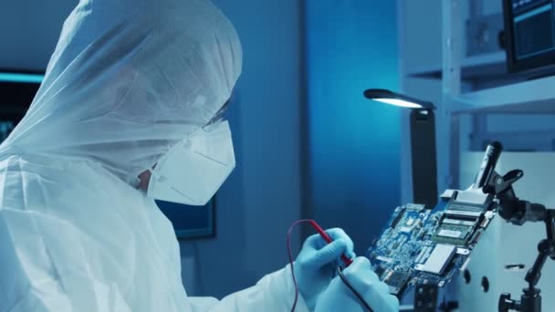 Mikroelektronikingenjör arbetar i ett modernt vetenskapligt laboratorium med datorsystem och mikroprocessorer. Elektronisk fabriksarbetare testar moderkortet och kodar den inbyggda programvaran. — Stockvideo