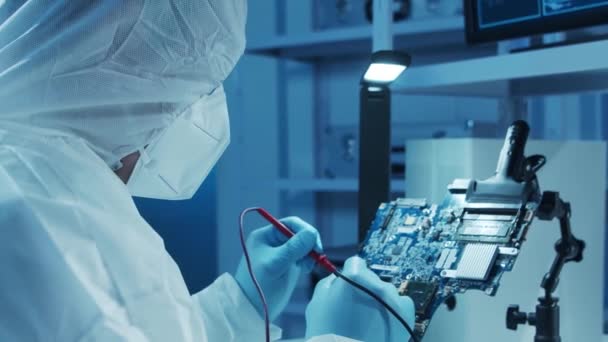 Micro-elektronica ingenieur werkt in een modern wetenschappelijk laboratorium aan computersystemen en microprocessoren. Elektronische fabrieksarbeider test het moederbord en codeert de firmware. — Stockvideo