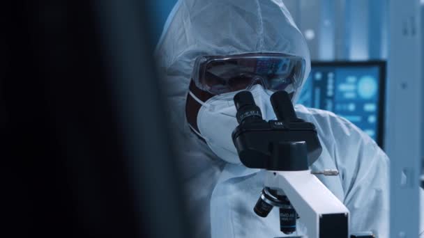 African-american microelectronics engineer works in a modern scientific laboratory on computing systems and microprocessors. Electronic factory worker is testing the motherboard and coding. — Stock Video