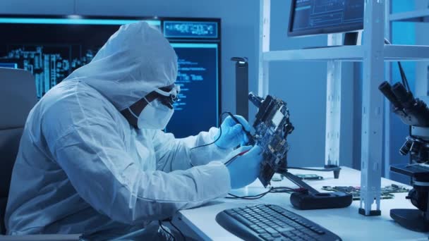 African-american microelectronics engineer works in a modern scientific laboratory on computing systems and microprocessors. Electronic factory worker is testing the motherboard and coding. — Stock Video