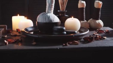 Spa arka planı. Mumlar, masaj taşları ve bitkisel toplar. Masaj, oryantal terapi, refah ve meditasyon.