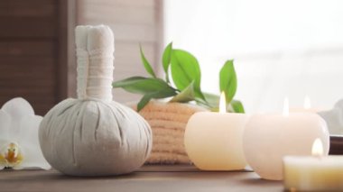 Spa arka planı. Havlu, mumlar, çiçekler, masaj taşları ve bitkisel toplar. Masaj, oryantal terapi, refah ve meditasyon.
