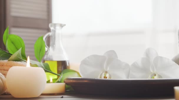 Fond de spa. Serviette, bougies, fleurs, pierres de massage et boules à base de plantes. Massage, thérapie orientale, bien-être et méditation. — Video