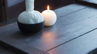 Spa arka planı. Mumlar, masaj taşları ve bitkisel toplar. Masaj, oryantal terapi, refah ve meditasyon.