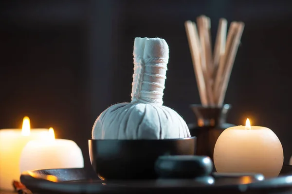 Spa background. Towel, candles, flowers, aroma sticks, massaging stones and herbal balls. Massage, oriental therapy, wellbeing and meditation. — Stock Photo, Image