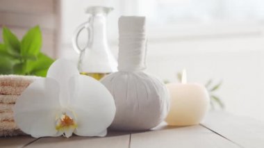 Spa arka planı. Havlu, mumlar, çiçekler, masaj taşları ve bitkisel toplar. Masaj, oryantal terapi, refah ve meditasyon.