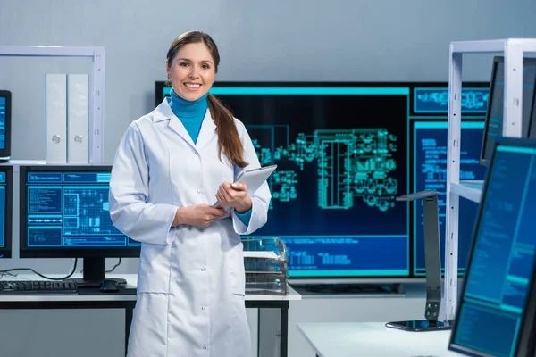 Female microelectronics engineer works in a scientific laboratory on computing systems and microprocessors. Professional electronic factory worker is testing the motherboard and coding the firmware. Royalty Free Stock Images