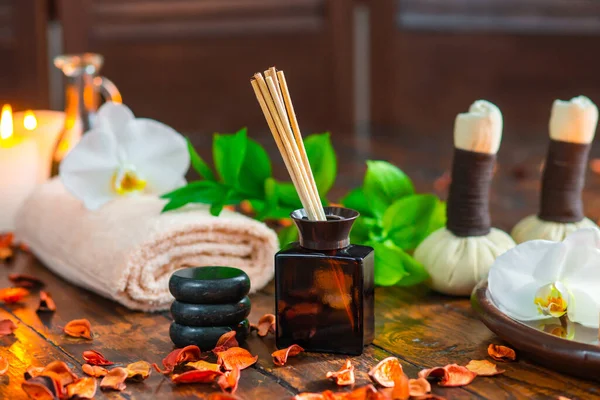 Fundo de spa. Toalha, velas, flores, palitos de aroma, pedras de massagem e bolas de ervas. Massagem, terapia oriental, bem-estar e meditação. — Fotografia de Stock