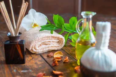 Spa arka planı. Havlu, mumlar, çiçekler, aroma çubukları, masaj taşları ve bitkisel toplar. Masaj, oryantal terapi, refah ve meditasyon kavramı.