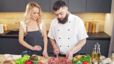 Genç kadın ve erkek yemek hazırlar ve bir yemek programı sunarlar. Blogcular mutfaktan yayın yapıyor. Sağlıklı yemek hazırlığı.