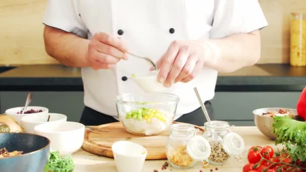 Young bereitet in einer modernen Küche eine Poke-Bowl zu. Der Mann bereitet zu Hause Essen zu. Gesundes Kochen. — Stockvideo