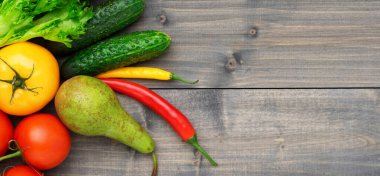 Sağlıklı ve lezzetli vejetaryen ve vejetaryen yemekleri hazırlamak için taze ürün seçimi. Masanın üzerinde çeşitli sebzeler ve meyveler var. Düz yatıyordu.