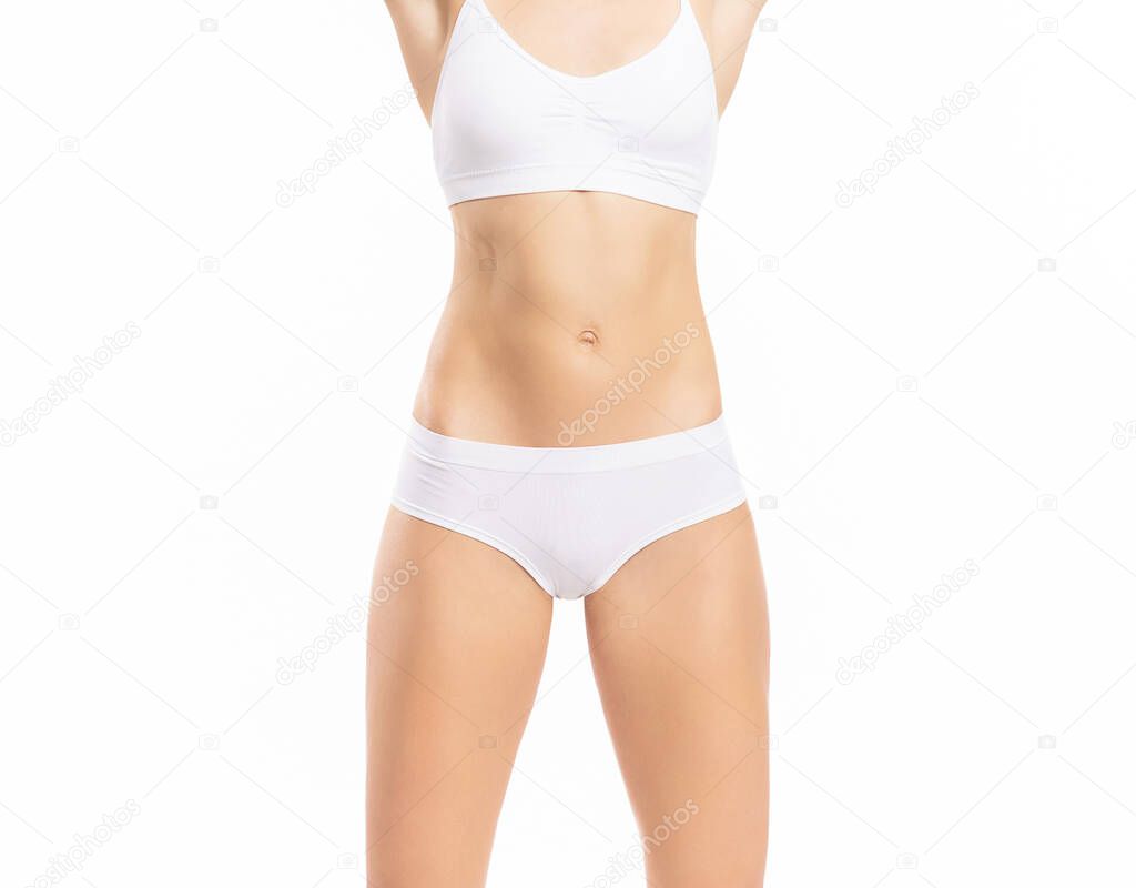 Close-up of a beautiful and fit female figure. Studio photo of young womans body in swimsuit.