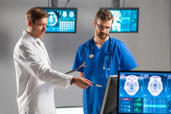 Professionele artsen werken in het ziekenhuis kantoor met behulp van computertechnologie. Geneeskunde, neurochirurgie en gezondheidszorg. — Stockfoto