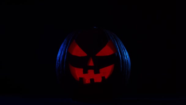 Scary laughing pumpkin on a dark background. Halloween, witchcraft and magic. — Stock Video