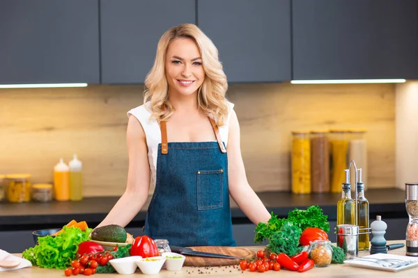 Jonge vrouw bereidt eten en organiseert een kookprogramma. De blogger stroomt vanuit de moderne keuken. Vegetarische gezonde voedselbereiding. — Stockfoto