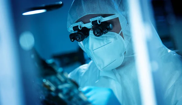 The scientist works in a modern scientific laboratory for the research and development of microelectronics and processors. Microprocessor manufacturing worker uses computer technology and equipment. — Stock Photo, Image