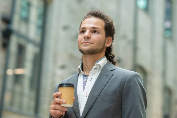 Um jovem empresário de sucesso está andando pela rua. Um homem de fato casual. Trabalho de negócios, freelance e remoto. — Fotografia de Stock